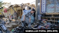 People gather at the scene of a previous blast in Kabul's Dasht-e Barchi area. (file photo)