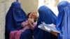 Afghan health workers administer polio vaccination drops to a child during an inoculation campaign in Jalalabad. (file photo)