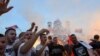 Opposition supporters celebrate victory in Montenegrin parliamentary elections in front of the Church of Christ's Resurrection in Podgorica