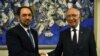 Afghan Foreign Minister, Salahuddin Rabbani (L), shakes hands with Sartaj Aziz, foreign affairs adviser to Pakistani Prime Minister Nawaz Sharif in August. 