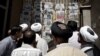 Clergymen read Iranian newspapers at a newsstand in the city of Qom. (file photo)