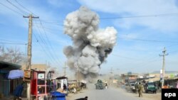 Smoke billows from the scene of a suicide bomb blast that targeted a police headquarters in Kunduz, on February 10.