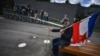 SERBIA -- An admirer wearing a protective mask holds a Yugoslavia flag as he sits on a bench in front of the late former President of communist Yugoslavia Josip Broz Tito (1892–1980) memorial complex, in Belgrade, May 25, 2020