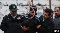 PHOTO GALLERY: In a dramatic scene at a scheduled public execution, an Iranian woman spared the life of her son's killer as he stood with a noose around his neck. The victim's relatives were tasked with pushing the chair out from under the convicted killer, but instead the victim's mother slapped him and then forgave him. The scene was captured in photographs by Arash Khamooshi of Iran's semiofficial ISNA news agency.