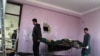 Afghan security officials carry a body of a suspected militant, in Mazar-e Sharif on January 5.